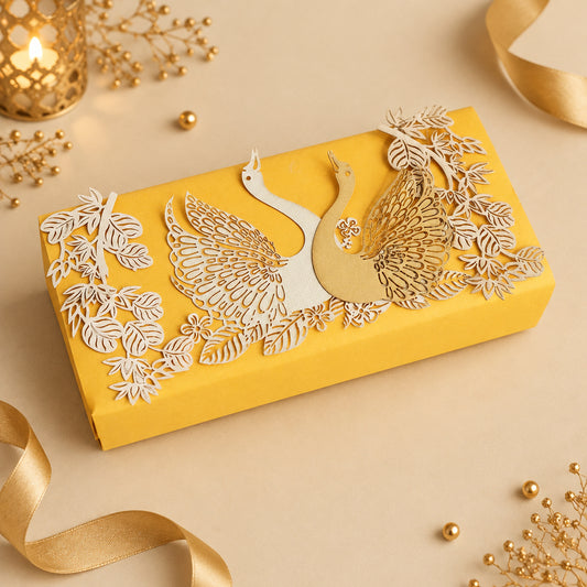Yellow cash box with gold and white bird design on a textured surface