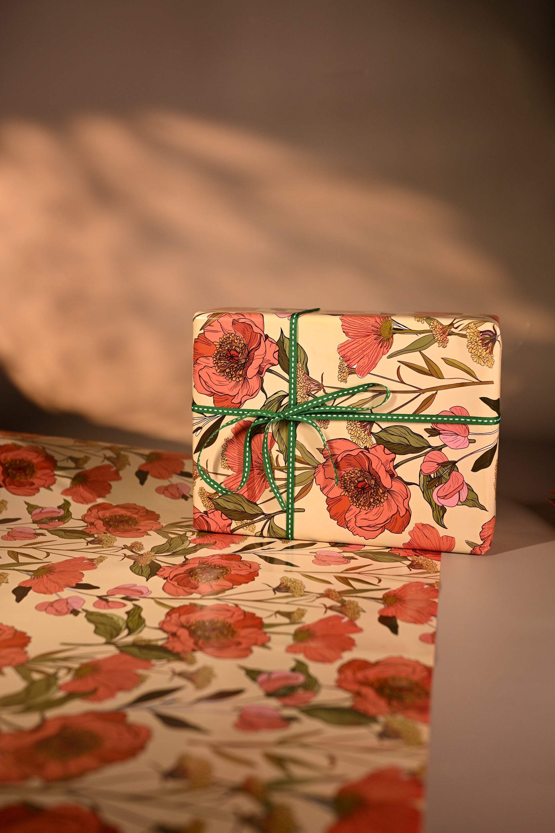 This reversible wrapping paper, having two distinct vibes—the bold, energetic orange and pink blooms on one side and the clean, white minimal design on the other—makes it such a versatile staple for a gift-wrap stash.