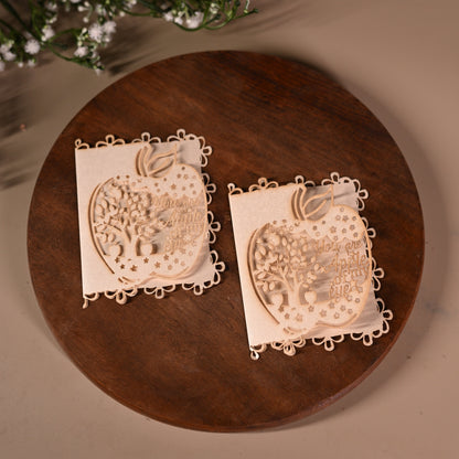 gift tag with laser cut apple design with tree inside it