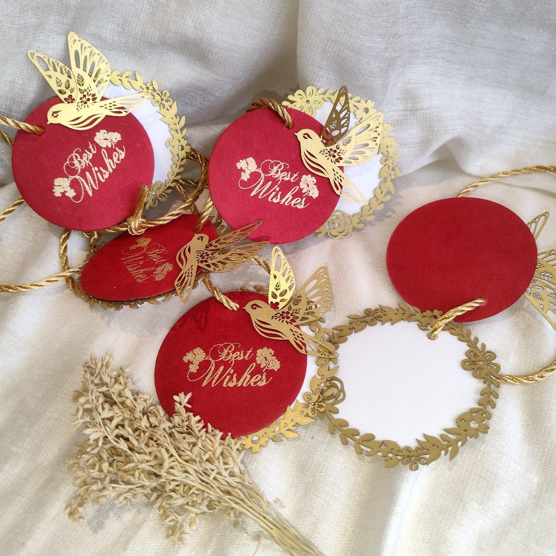 Layered red gift tags with gold 'Best Wishes' text and gold bird cut-outs, in laser cut detailing
