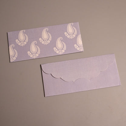 avender paper, one with a white paisley pattern and the other with a scalloped envelope flap