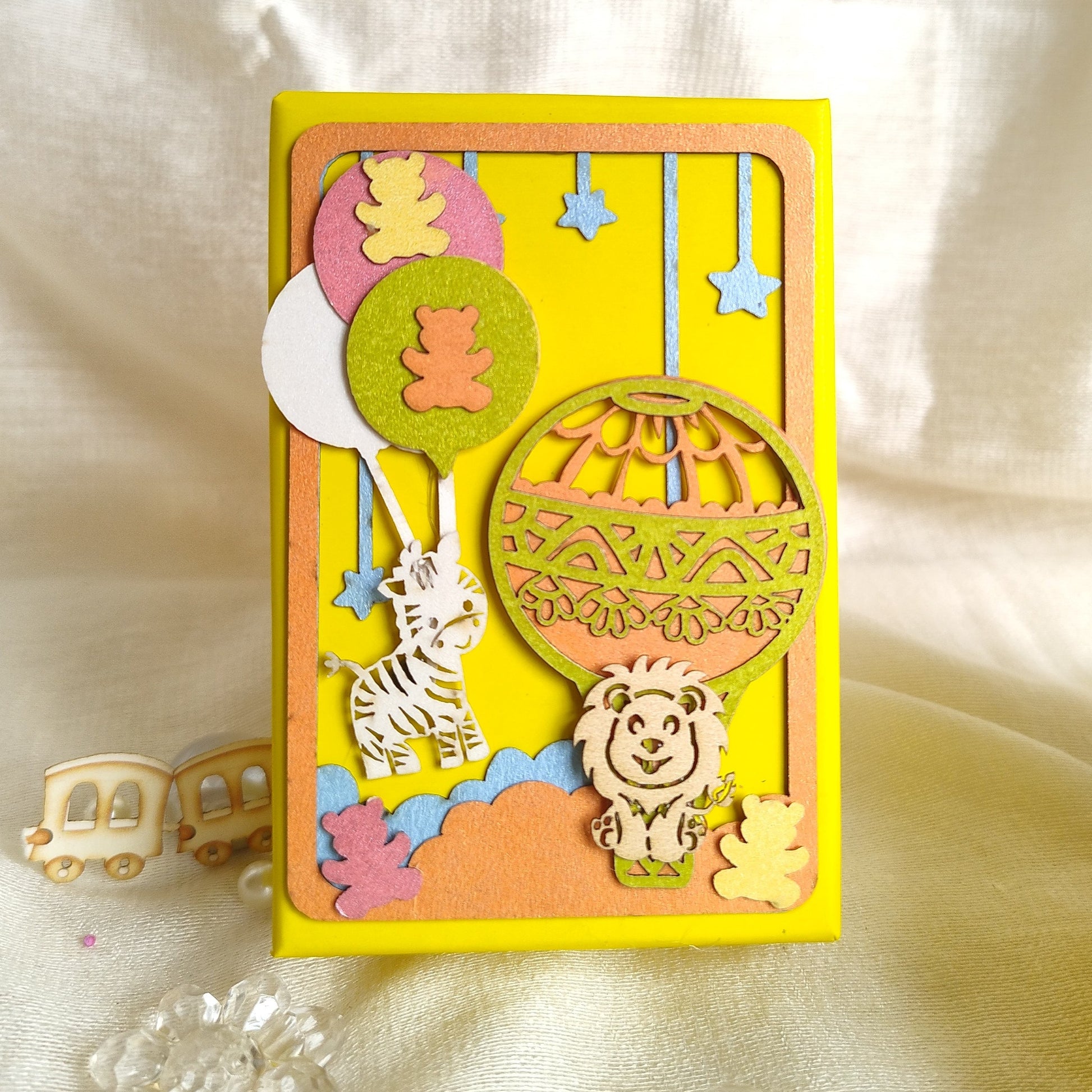 Lemon yellow coin box with animals and parachutes made with laser cutting and texture paper