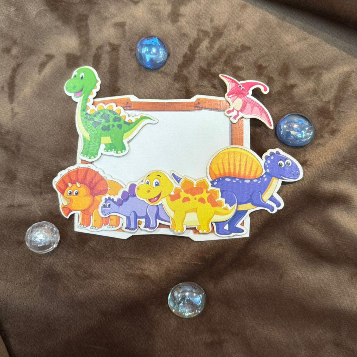 Colorful dinosaurs on a white gift tag for kids