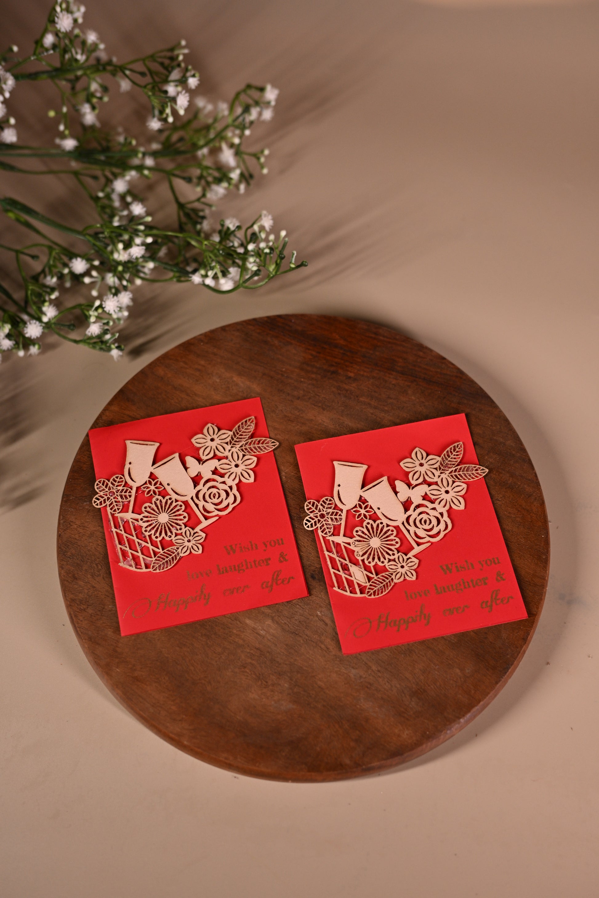 red gift tags with floral laser-cut patchwork and drinking glasses