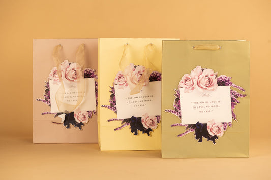 Gift bags with a light pastel background, each adorned with a floral sticker design. There is also a space for writing personalized messages.
