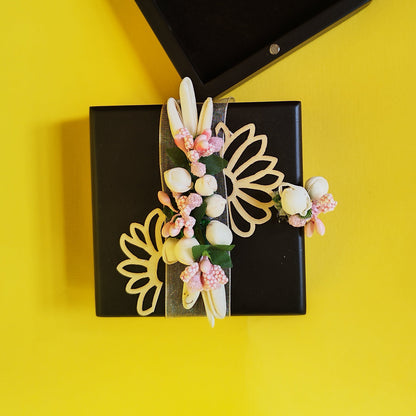 A brown coin box with a floral design, featuring a secure magnetic lock and adorned with artificial flowers.