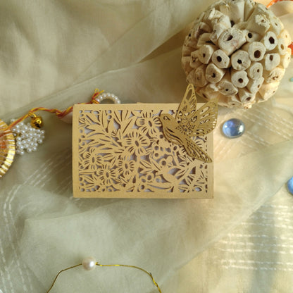 cream colour full jali coin box with intricately laser-cut floral patterns and a bird