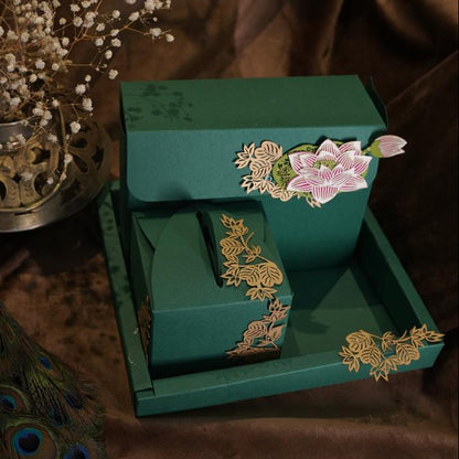 Green coloured dry fruit box set with laser-cut lotus and foliage embellishments