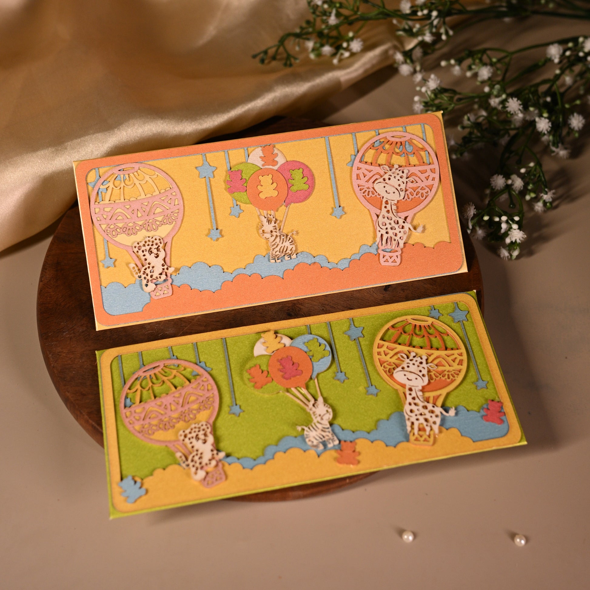 parachute  and animal envelopes on bright backgrounds and featuring intricate laser cut work.