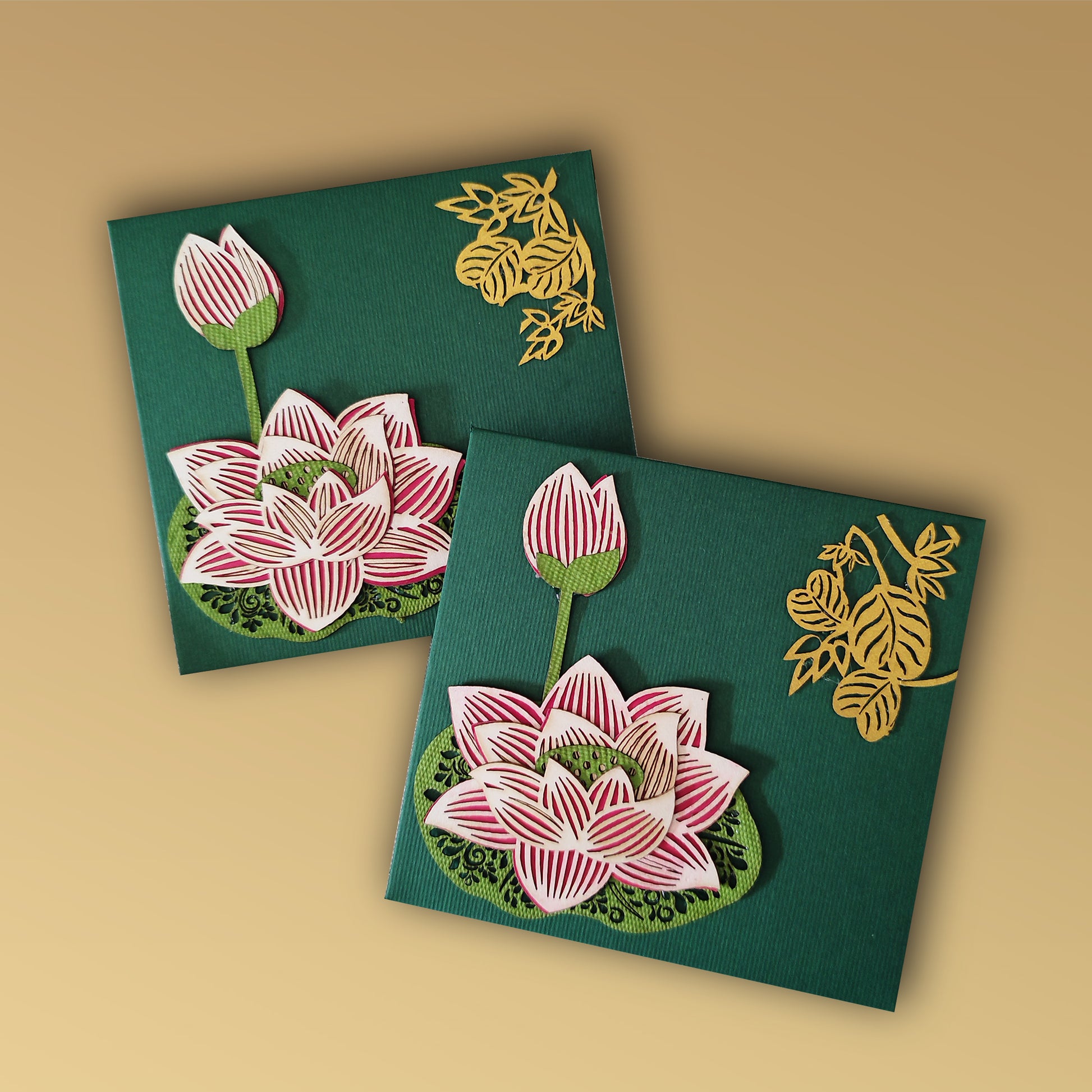 small green lotus envelope with laser-cut lotus work on one side and golden leaf motifs on the other