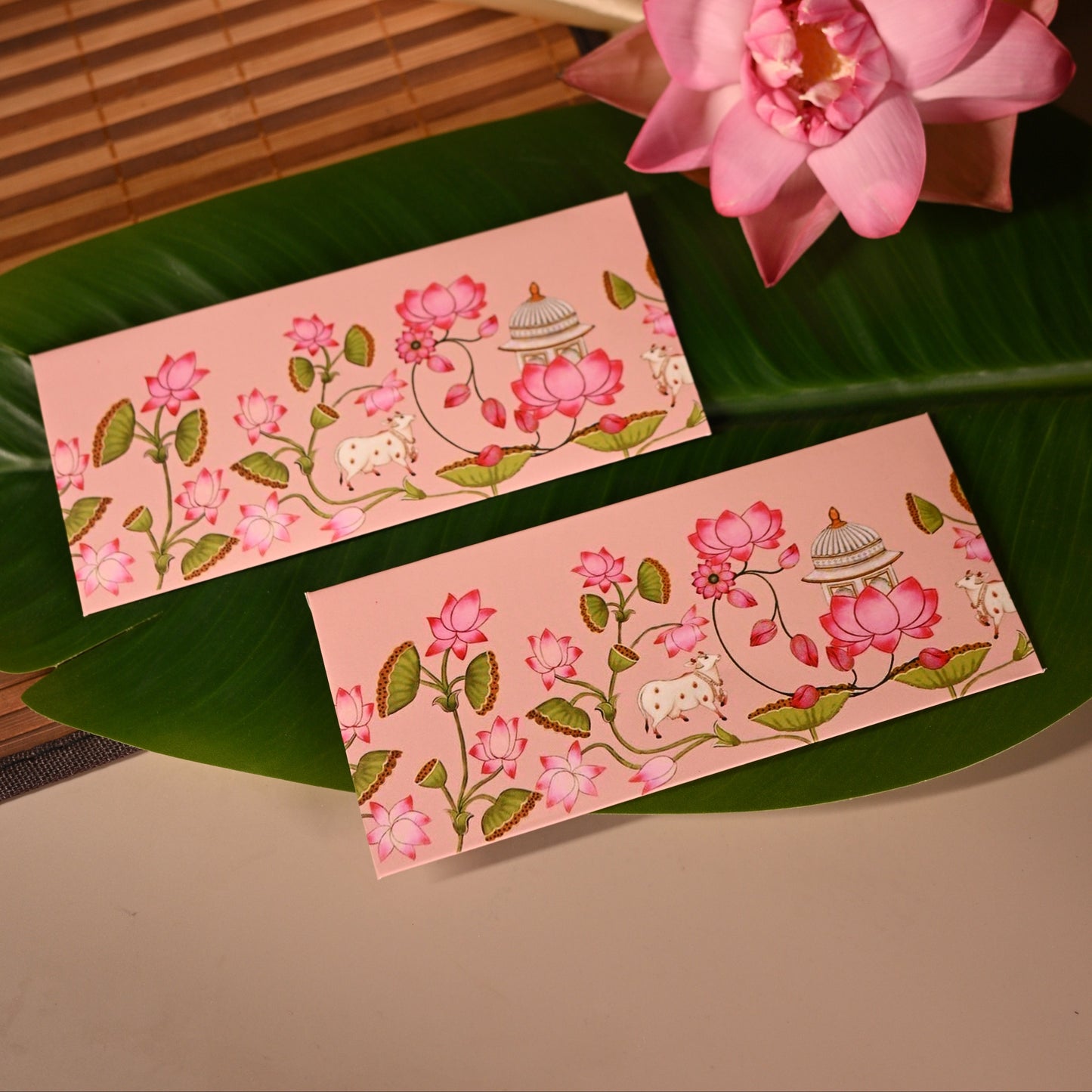 this soft pink envelope features intricate pichwai designs