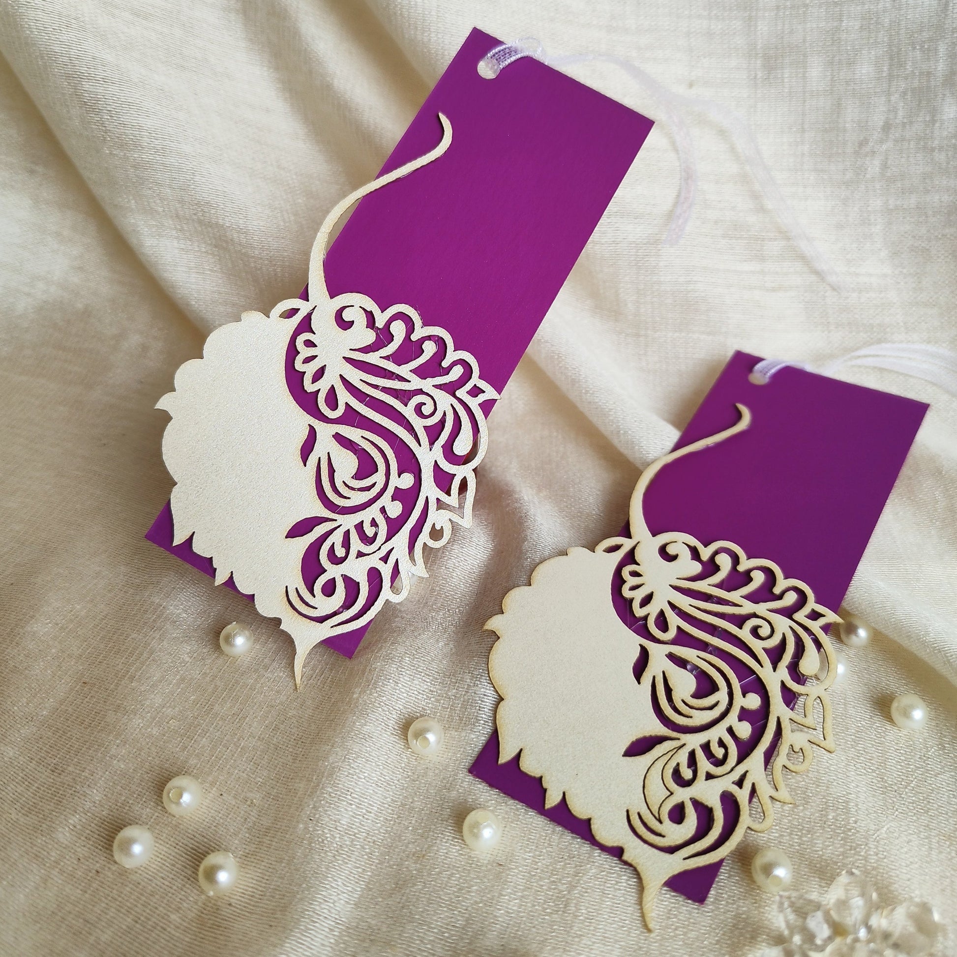 Laser-cut gift tags with a Pipal leaf design, in purple and white colours