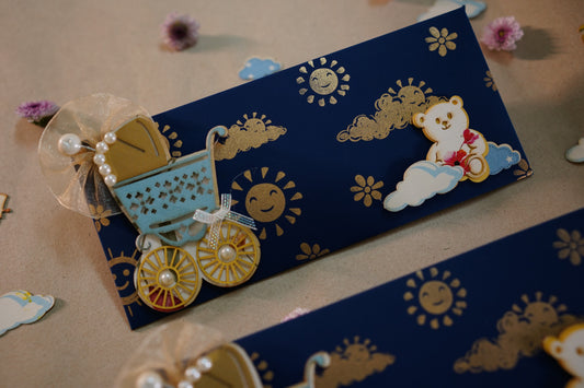 A blue envelope with a decorative baby pram and teddy bear design, with sun and clouds in the background