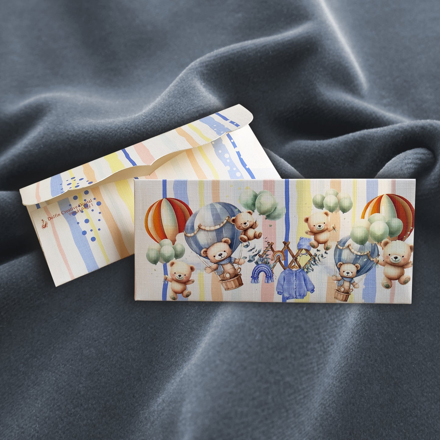 Two printed envelopes with teddy bear and parachute designs 
