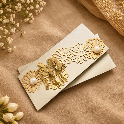 silver envelope with gold acrylic radha krishna and fowers with pearls on them