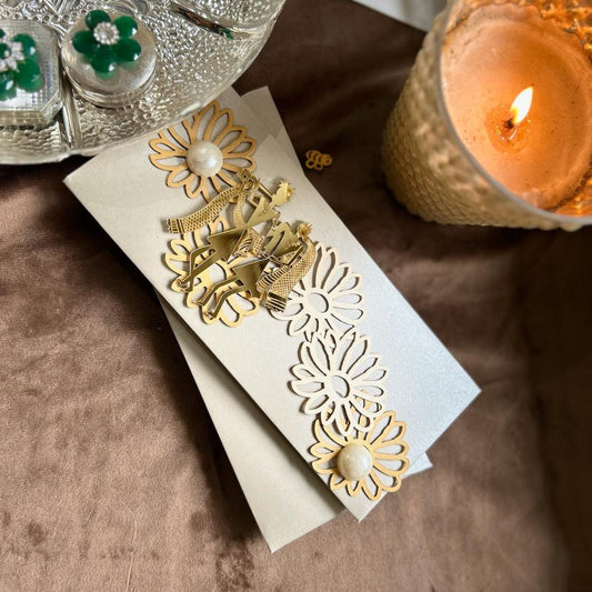silver envelope with gold acrylic radha krishna and fowers with pearls on them