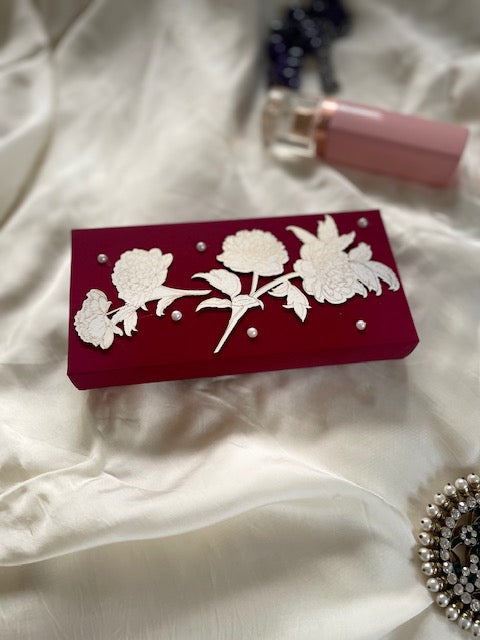 red cash box with gold print white flower