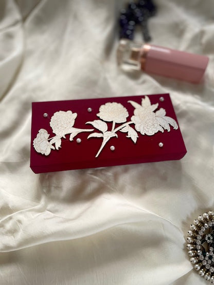 red cash box with gold print white flower