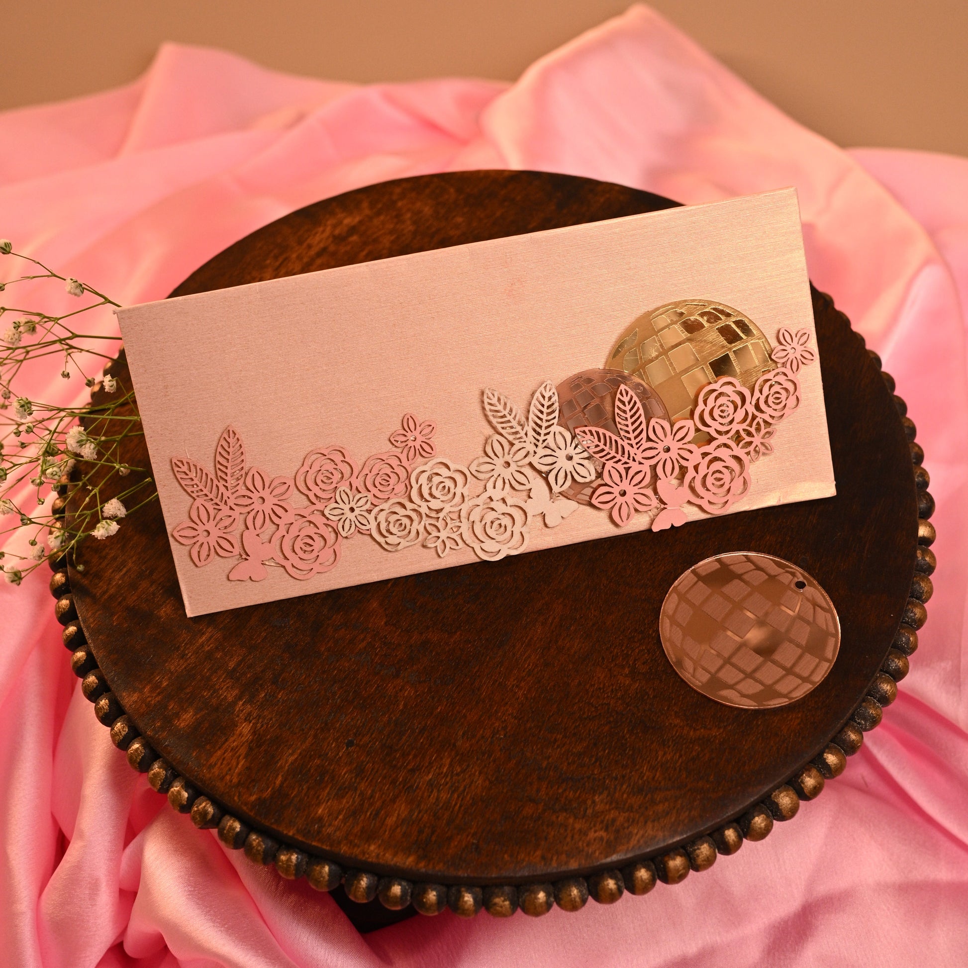 retro envelope with acrylic disco balls and laser-cut floral design