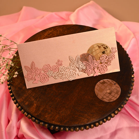 retro envelope with acrylic disco balls and laser-cut floral design