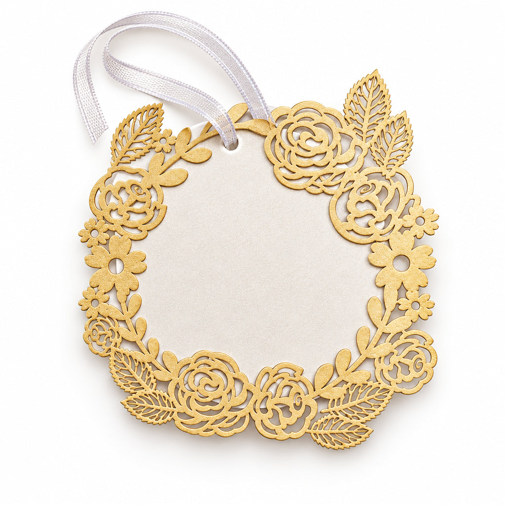 A circular laser-cut paper tag with an intricate floral and rose pattern, featuring a light purple ribbon loop at the top