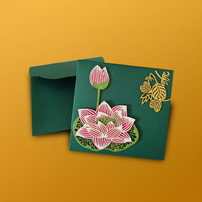 small green lotus envelope with laser-cut lotus work on one side and golden leaf motifs on the other
