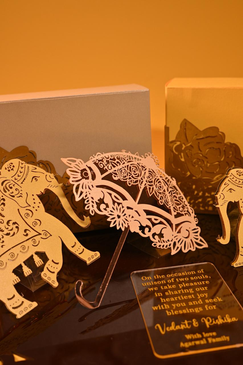A premium dry fruit box crafted from 350 GSM board paper, adorned with two elephant cutouts and an umbrella.
An acrylic place mat that serves as the hamper's base and doubles as a stylish centerpiece for your table.
An acrylic name plate with personalized wishes.