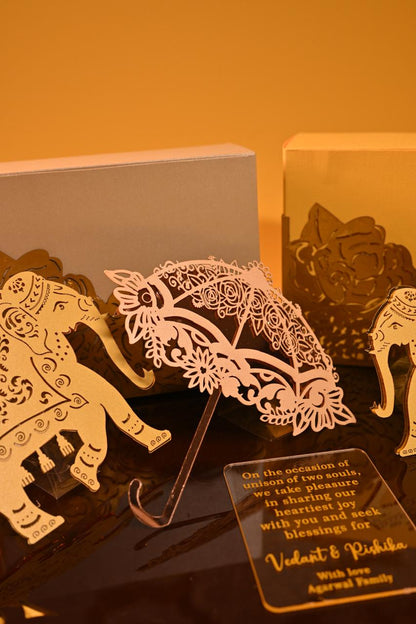 A premium dry fruit box crafted from 350 GSM board paper, adorned with two elephant cutouts and an umbrella.
An acrylic place mat that serves as the hamper's base and doubles as a stylish centerpiece for your table.
An acrylic name plate with personalized wishes.