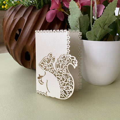 gift tag featuring laser cut squirrel design with intricate detailing inside it