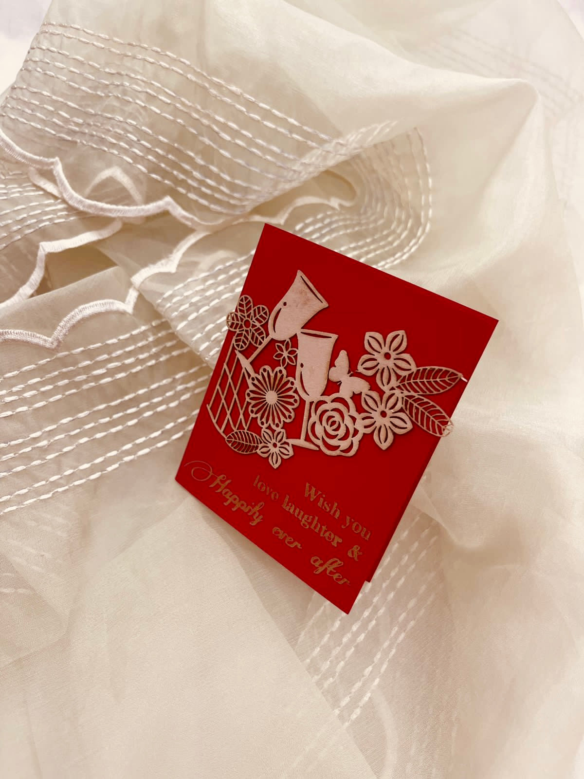red gift tags with floral laser-cut patchwork and drinking glasses